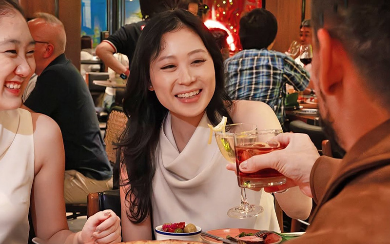 Friends laughing and enjoying drinks at Publico.