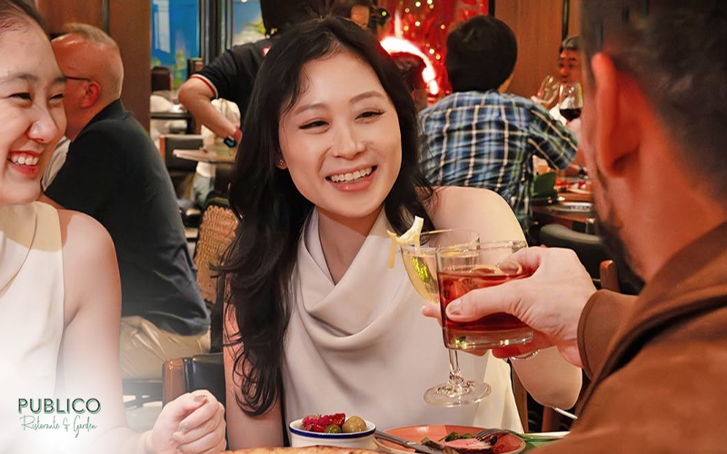 Friends laughing and enjoying drinks at Publico.