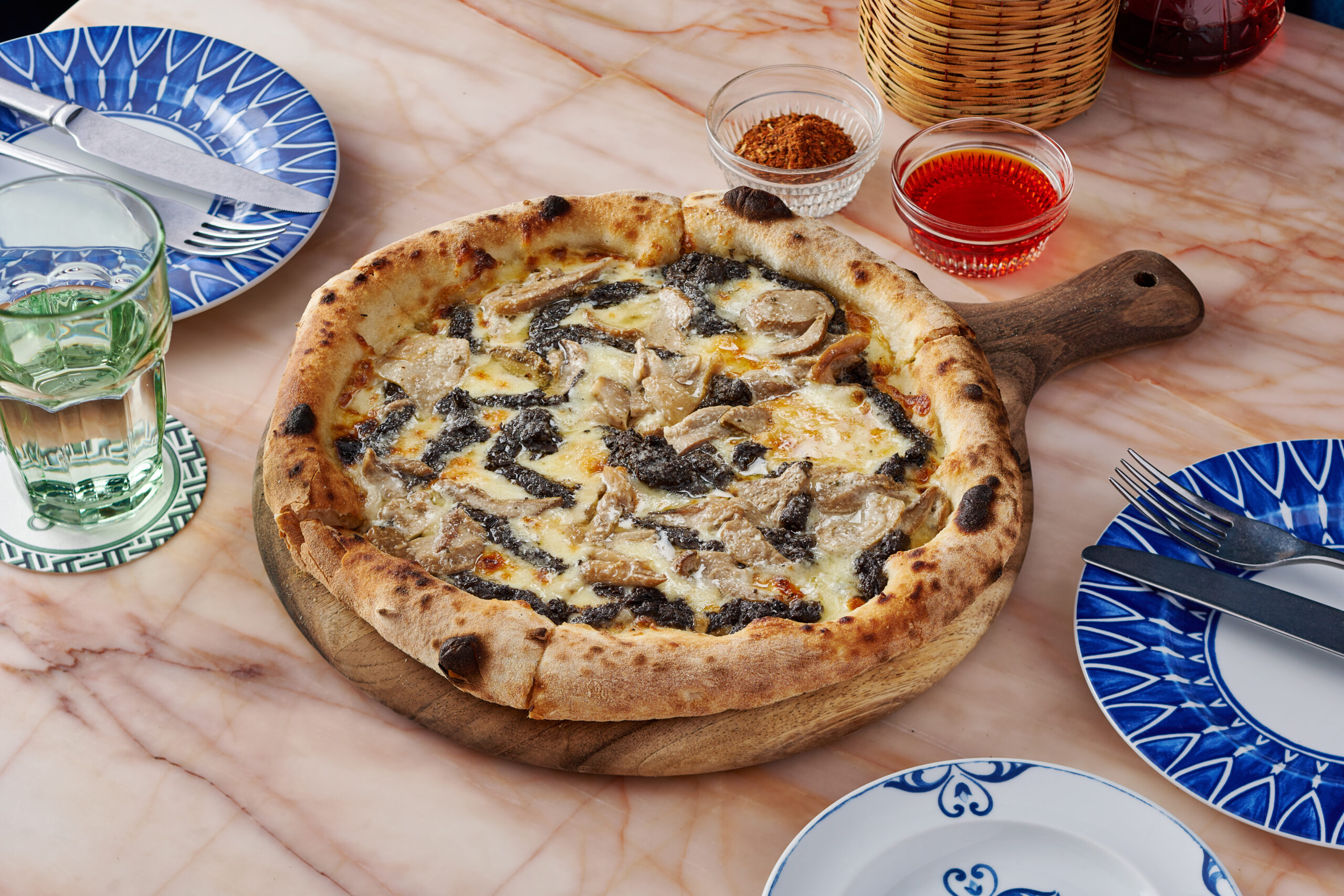 Wood-fired pizza baking in a traditional stone oven