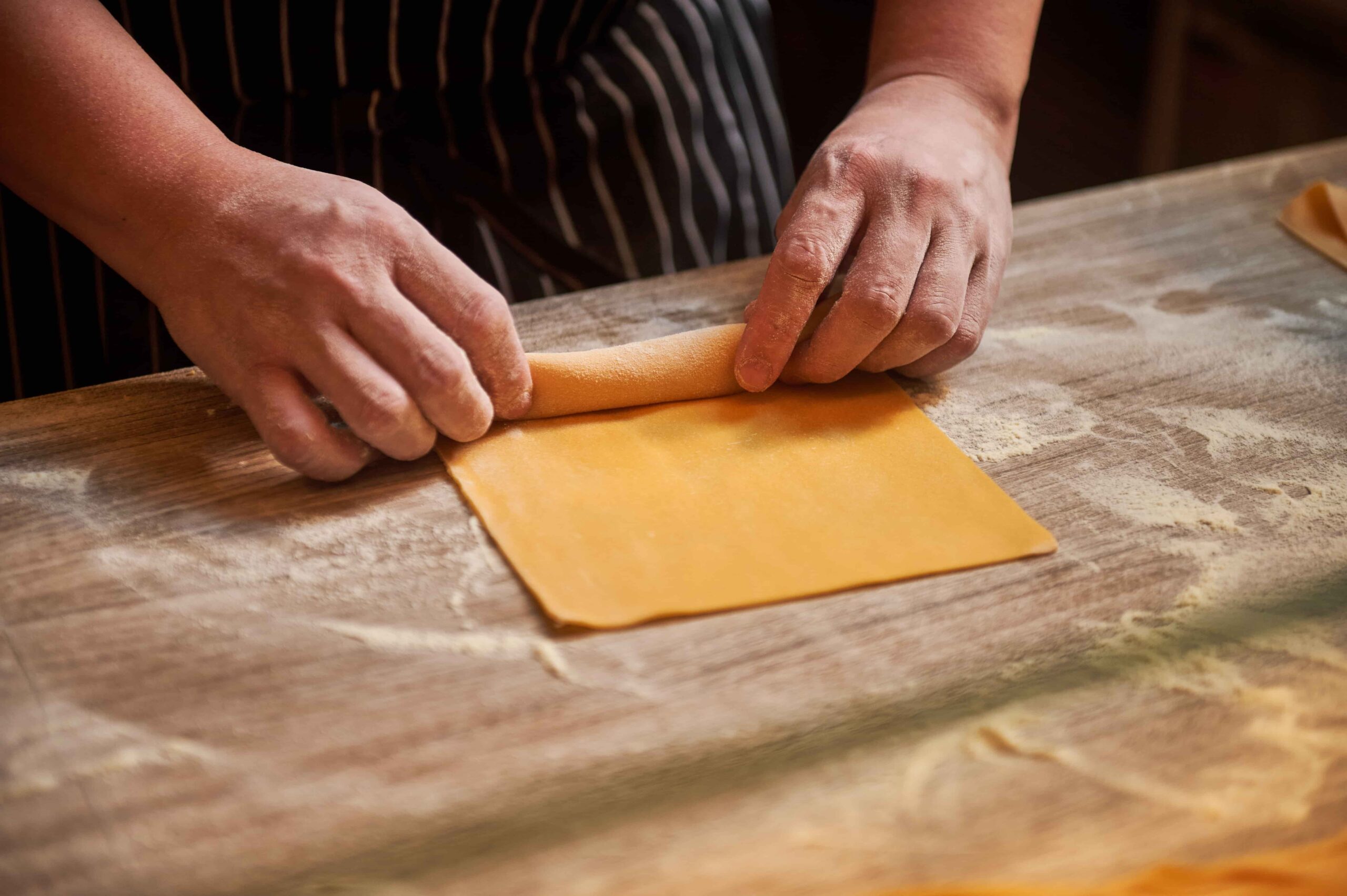 Chef preparing fresh handmade pasta at Publico Ristorante, an Italian restaurant in Robertson Quay, Singapore.