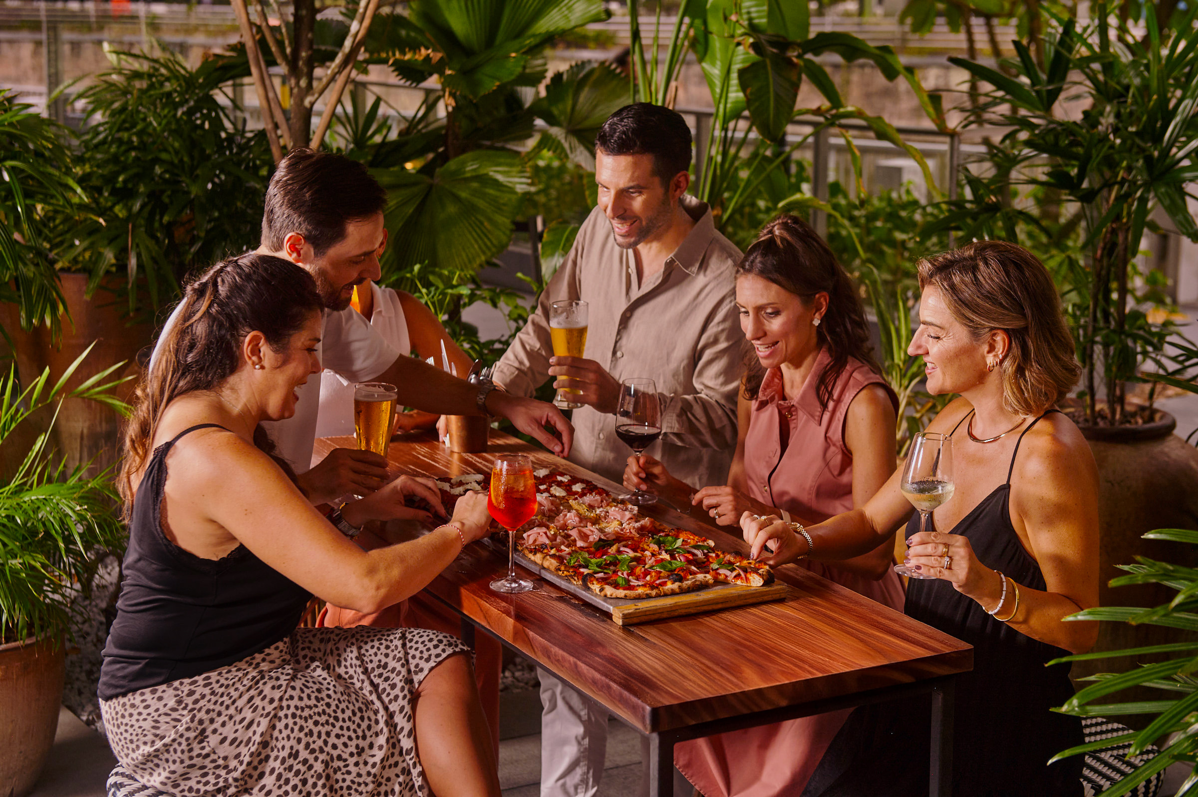 Guests enjoying pizza and drinks at The Pit at Publico during Singapore Grand Prix weekend