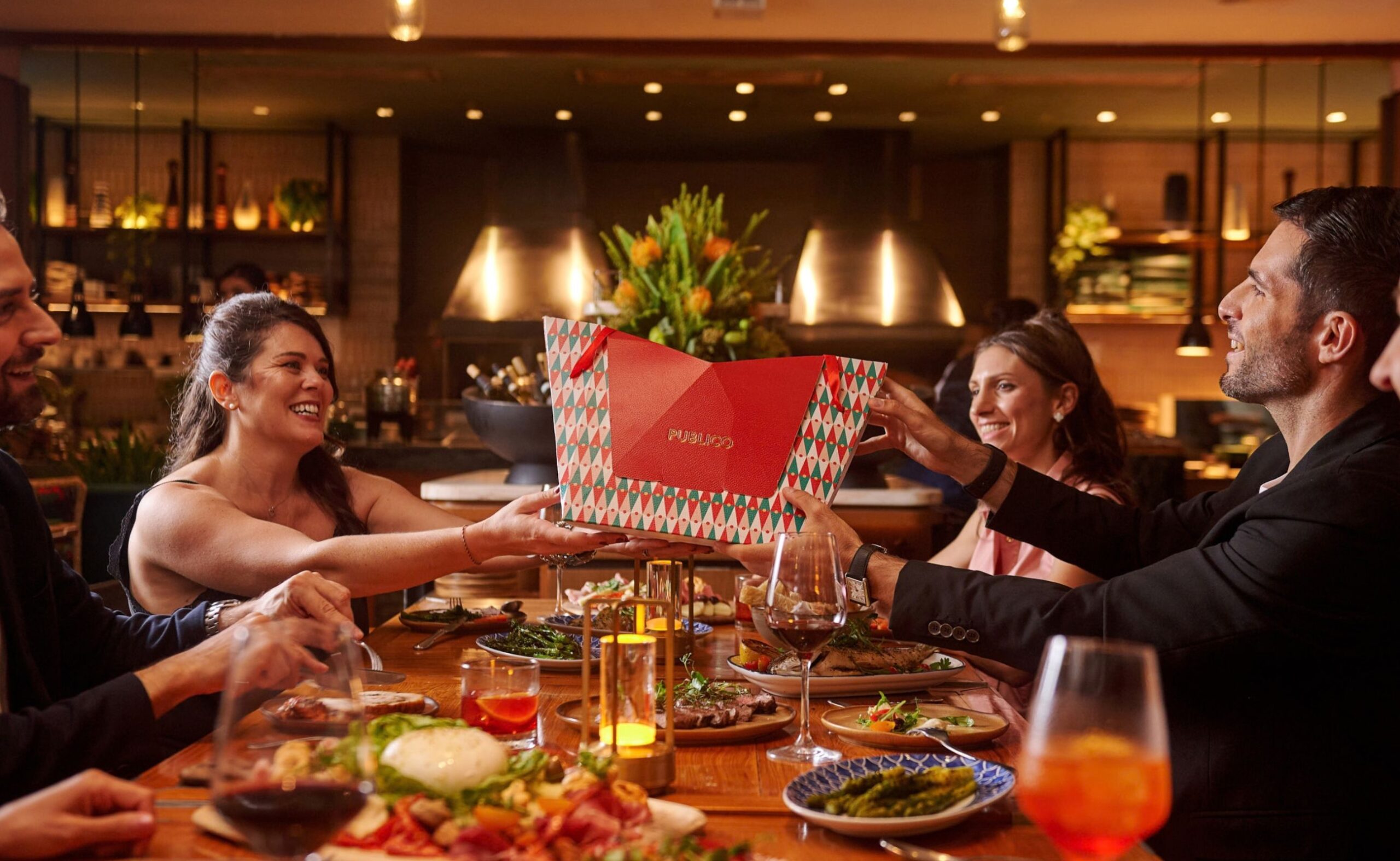 Festive group dining at Publico Ristorante with friends sharing an Italian meal