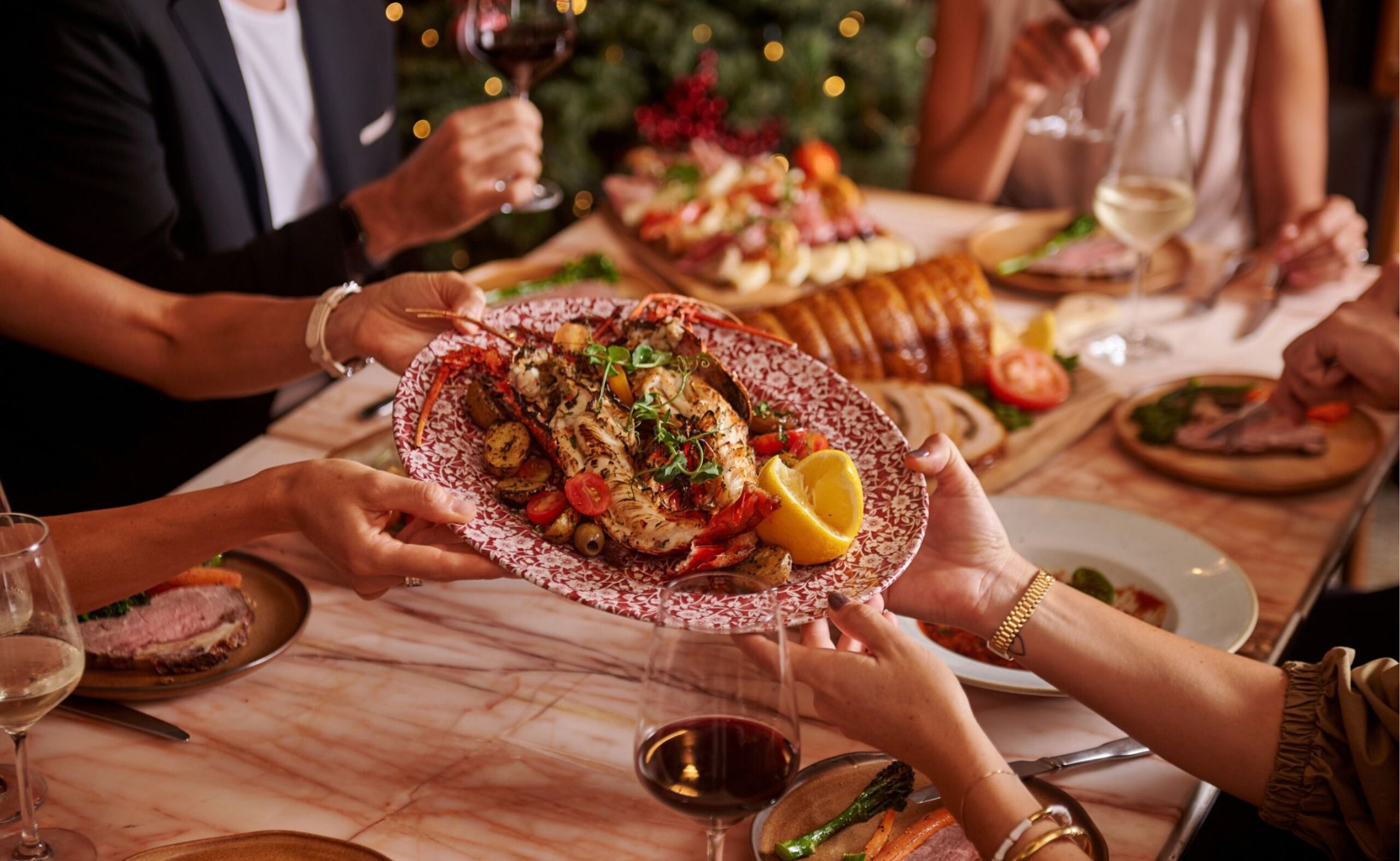 Guests sharing Italian dishes around a dining table at Publico Ristorante, Robertson Quay