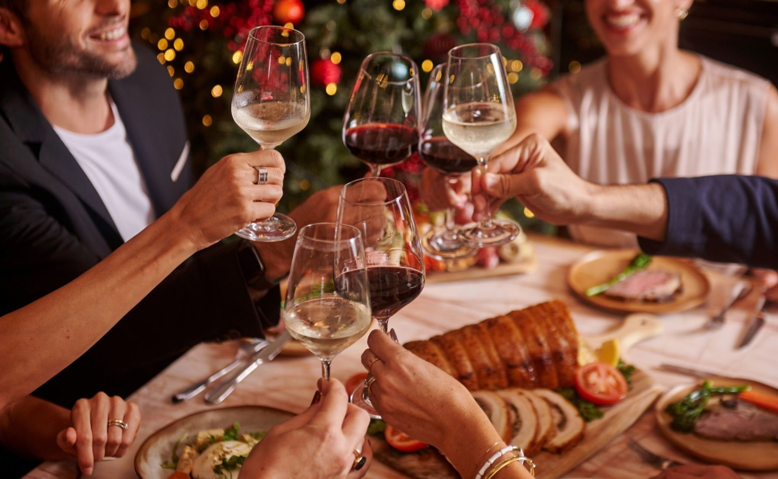 Guests raising glasses around a table of Italian food at Publico Ristorante